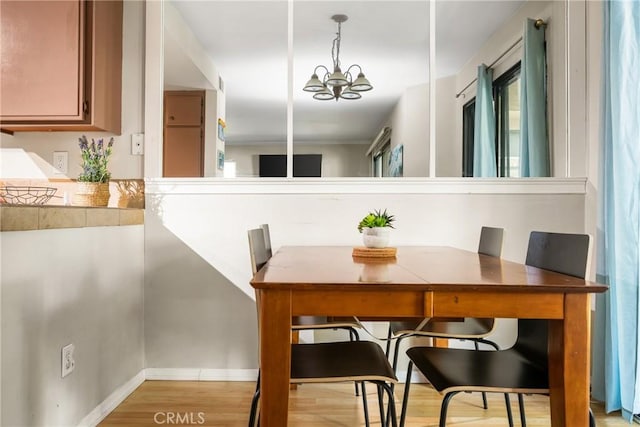 400 Brighton Spgs, Costa Mesa, CA 92627 - dining area featuring a chandelier and light wood finished floors