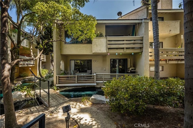 400 Brighton Spgs, Costa Mesa, CA 92627 - rear view of property featuring a balcony and stucco siding