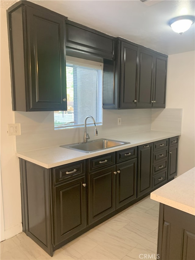 14299 La Paz Dr Unit 6, Victorville, CA 92395 - kitchen featuring light countertops and dark cabinetry
