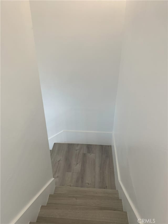 14299 La Paz Dr Unit 6, Victorville, CA 92395 - stairs featuring wood finished floors and baseboards
