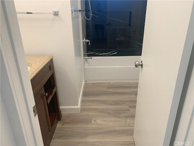 14299 La Paz Dr Unit 6, Victorville, CA 92395 - bathroom featuring vanity, wood finished floors, and washtub / shower combination