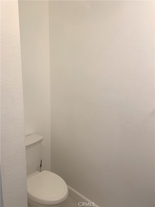 14299 La Paz Dr Unit 6, Victorville, CA 92395 - bathroom with toilet and baseboards