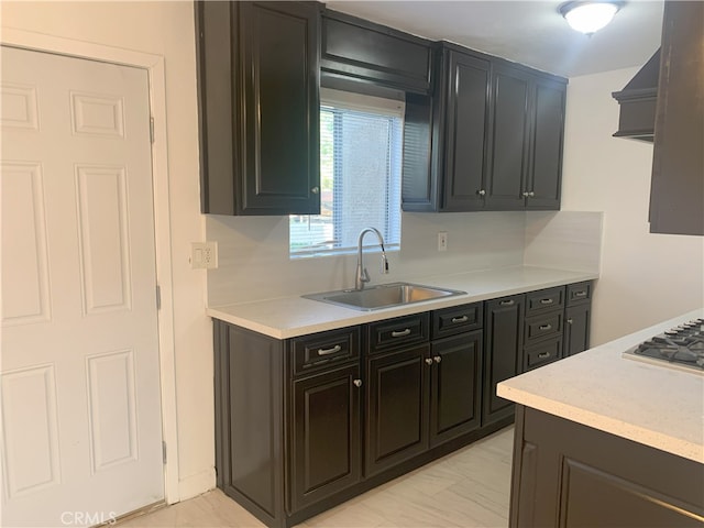 14299 La Paz Dr Unit 6, Victorville, CA 92395 - kitchen featuring light countertops, stainless steel gas stovetop, and dark cabinets