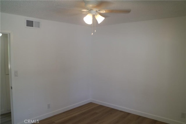 14299 La Paz Dr Unit 6, Victorville, CA 92395 - empty room featuring a ceiling fan, dark wood-style floors, and a textured ceiling