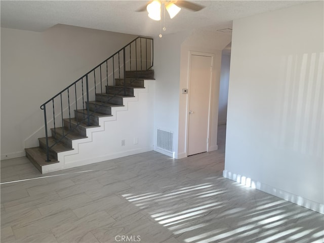 14299 La Paz Dr Unit 6, Victorville, CA 92395 - stairs featuring a ceiling fan and a textured ceiling