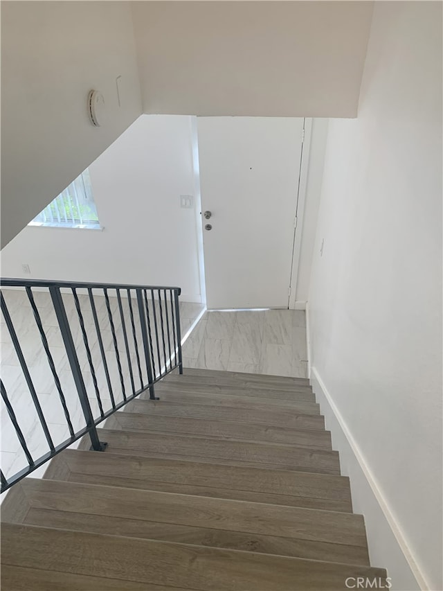 14299 La Paz Dr Unit 6, Victorville, CA 92395 - stairway featuring wood finished floors