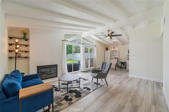 1925 W Beacon Ave, Anaheim, CA 92804 - living area with a fireplace, light wood-style flooring, a ceiling fan, and a chandelier