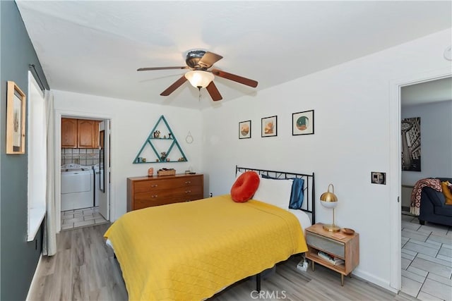 22989 Pine Ln, Crestline, CA 92325 - bedroom with washing machine and clothes dryer, connected bathroom, light wood-type flooring, and ceiling fan