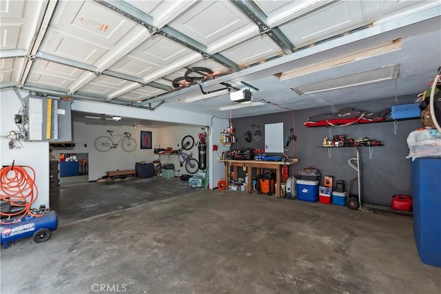 22989 Pine Ln, Crestline, CA 92325 - garage featuring a garage door opener and a workshop area