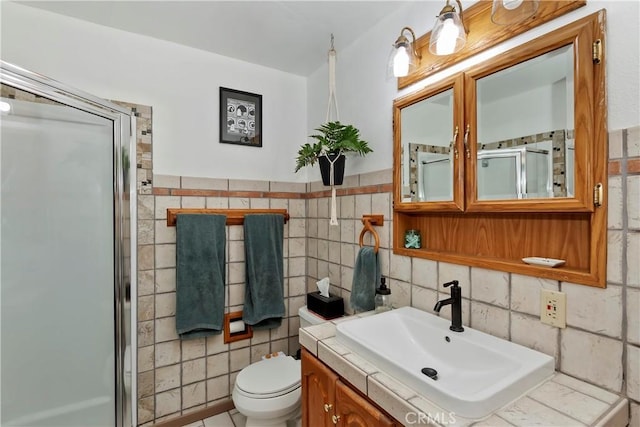 22989 Pine Ln, Crestline, CA 92325 - full bathroom with a stall shower, vanity, tile walls, and wainscoting