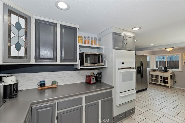 22989 Pine Ln, Crestline, CA 92325 - kitchen featuring stainless steel appliances, tasteful backsplash, gray cabinets, a warming drawer, and recessed lighting
