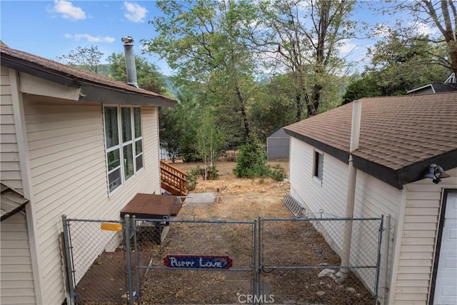 29289 Lake View Dr, Cedar Glen, CA 92321 - view of side of home featuring a gate and a shingled roof