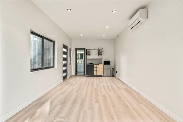 2315 Loma Vista Pl, Los Angeles, CA 90039 - unfurnished living room with an AC wall unit, light wood-type flooring, and recessed lighting