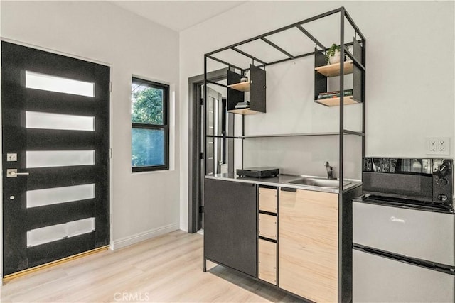 2315 Loma Vista Pl, Los Angeles, CA 90039 - kitchen with light wood-type flooring, open shelves, refrigerator, and light countertops