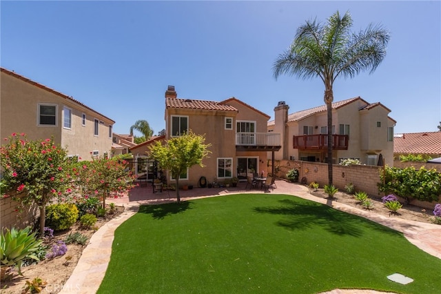 15535 Mallory Ct, Moorpark, CA 93021 - rear view of house with a chimney, stucco siding, a patio, a balcony, and a tile roof