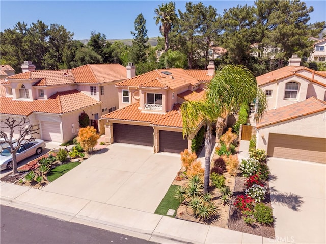 15535 Mallory Ct, Moorpark, CA 93021 - mediterranean / spanish home with a tile roof, driveway, stucco siding, a garage, and a chimney