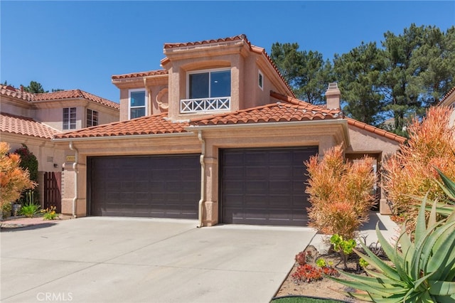 15535 Mallory Ct, Moorpark, CA 93021 - mediterranean / spanish-style house featuring concrete driveway, a tiled roof, a chimney, a garage, and stucco siding