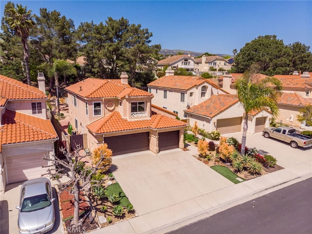 15535 Mallory Ct, Moorpark, CA 93021 - view of front facade with a tile roof, a residential view, stucco siding, concrete driveway, and a chimney