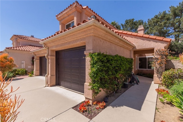15535 Mallory Ct, Moorpark, CA 93021 - mediterranean / spanish-style home with a tiled roof, a chimney, stucco siding, and concrete driveway
