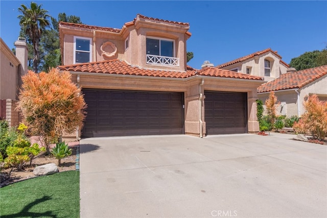 15535 Mallory Ct, Moorpark, CA 93021 - mediterranean / spanish house with a tile roof, driveway, stucco siding, and a garage
