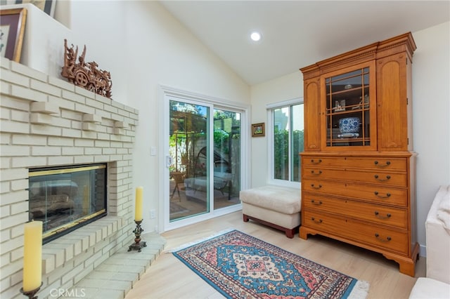 15535 Mallory Ct, Moorpark, CA 93021 - living room with light wood finished floors, recessed lighting, high vaulted ceiling, and a brick fireplace