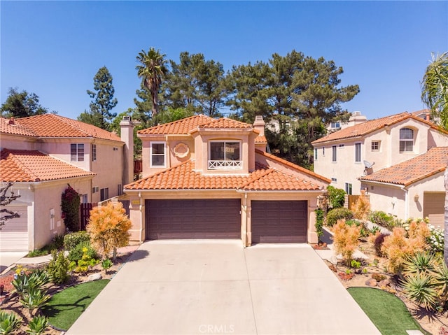 15535 Mallory Ct, Moorpark, CA 93021 - mediterranean / spanish home with a tiled roof, stucco siding, driveway, and a chimney