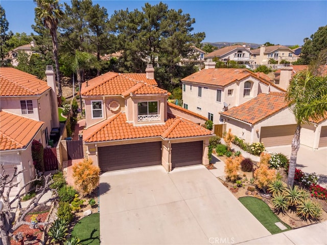 15535 Mallory Ct, Moorpark, CA 93021 - mediterranean / spanish home with a tiled roof, a residential view, concrete driveway, a chimney, and stucco siding