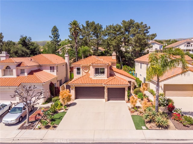 15535 Mallory Ct, Moorpark, CA 93021 - mediterranean / spanish-style house featuring a tiled roof, a chimney, concrete driveway, stucco siding, and a residential view
