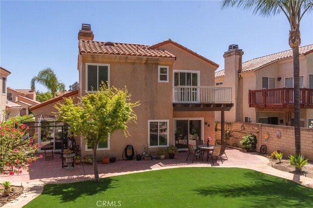 15535 Mallory Ct, Moorpark, CA 93021 - rear view of property featuring a patio, a chimney, stucco siding, a balcony, and a tiled roof