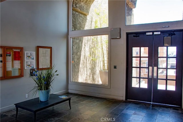 4727 W 147th St Unit 251, Lawndale, CA 90260 - entryway with a towering ceiling, stone tile floors, and french doors