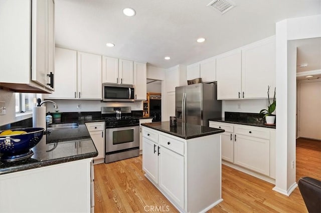 44938 Tehachapi, Temecula, CA 92592 - kitchen with appliances with stainless steel finishes, light wood-style flooring, white cabinetry, and recessed lighting