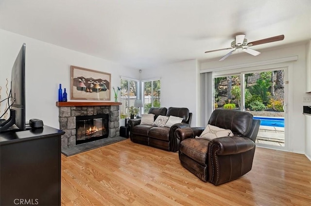 44938 Tehachapi, Temecula, CA 92592 - living area featuring a stone fireplace, ceiling fan, and light wood finished floors