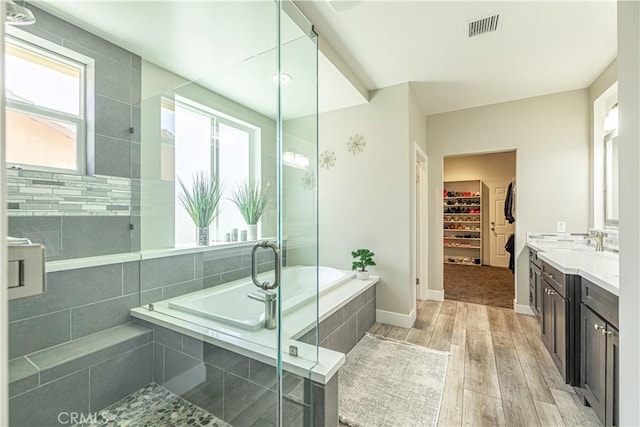 4664 Quartz Hill Rd, Quartz Hill, CA 93536 - bathroom featuring plenty of natural light, vanity, wood finished floors, and a garden tub