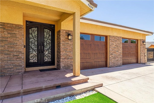 4664 Quartz Hill Rd, Quartz Hill, CA 93536 - entrance to property featuring stucco siding, french doors, a garage, and concrete driveway