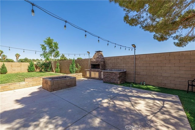 4664 Quartz Hill Rd, Quartz Hill, CA 93536 - fenced backyard featuring an outdoor fireplace and a patio area