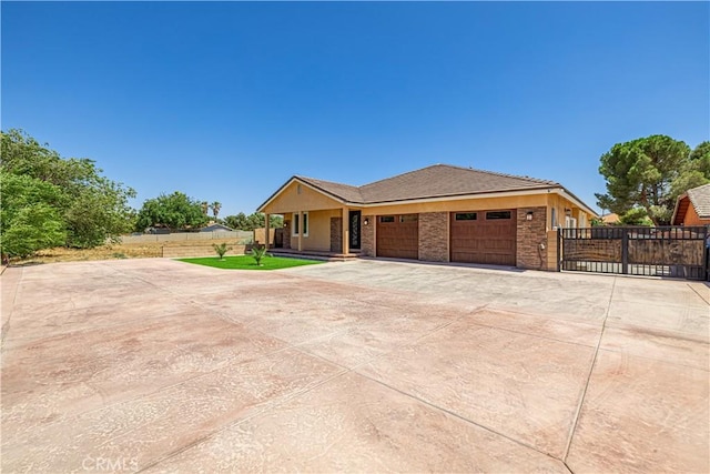 4664 Quartz Hill Rd, Quartz Hill, CA 93536 - ranch-style home featuring an attached garage, driveway, stone siding, and a gate