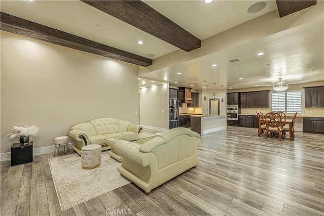 4664 Quartz Hill Rd, Quartz Hill, CA 93536 - living room with light wood finished floors, beamed ceiling, a chandelier, and recessed lighting