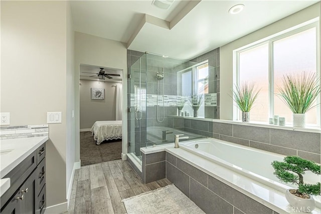4664 Quartz Hill Rd, Quartz Hill, CA 93536 - ensuite bathroom featuring vanity, a bath, a stall shower, wood finished floors, and a ceiling fan