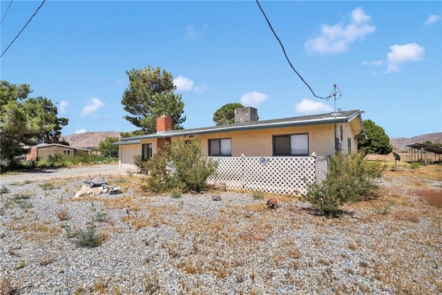 15761 Joshua Rd, Apple Valley, CA 92307 - view of front of property featuring a chimney and a mountain view