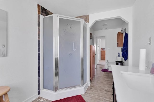15761 Joshua Rd, Apple Valley, CA 92307 - full bathroom with a shower stall, vanity, and wood finished floors