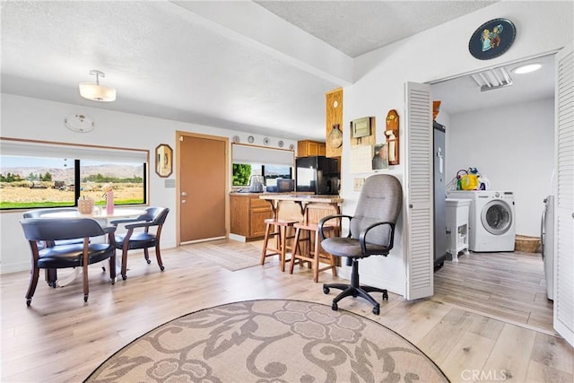 15761 Joshua Rd, Apple Valley, CA 92307 - living room with washer / clothes dryer and light wood-style floors