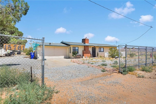 15761 Joshua Rd, Apple Valley, CA 92307 - ranch-style home featuring a chimney, an attached garage, and concrete driveway
