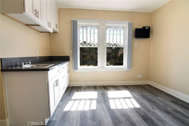 1703 Toberman St, Los Angeles, CA 90015 - kitchen with dark countertops, white cabinets, and dark wood-style flooring