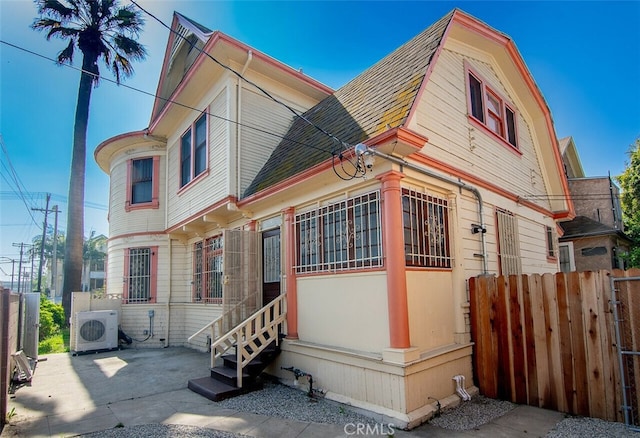 1703 Toberman St, Los Angeles, CA 90015 - view of side of property with a shingled roof, a gambrel roof, and a patio area