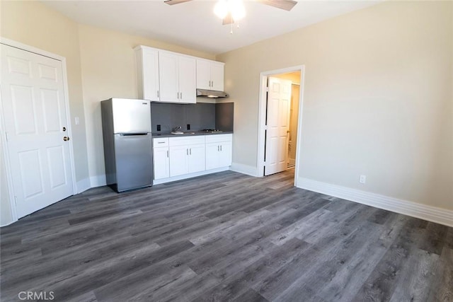 1703 Toberman St, Los Angeles, CA 90015 - kitchen featuring freestanding refrigerator, under cabinet range hood, a ceiling fan, white cabinetry, and dark wood-type flooring