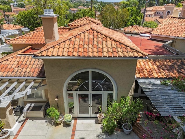71 Via Barcaza, Coto De Caza, CA 92679 - rear view of property with french doors, a tile roof, a chimney, and stucco siding