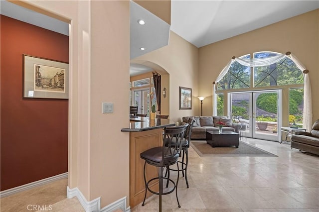 71 Via Barcaza, Coto De Caza, CA 92679 - bar area featuring arched walkways, a high ceiling, and light tile patterned flooring