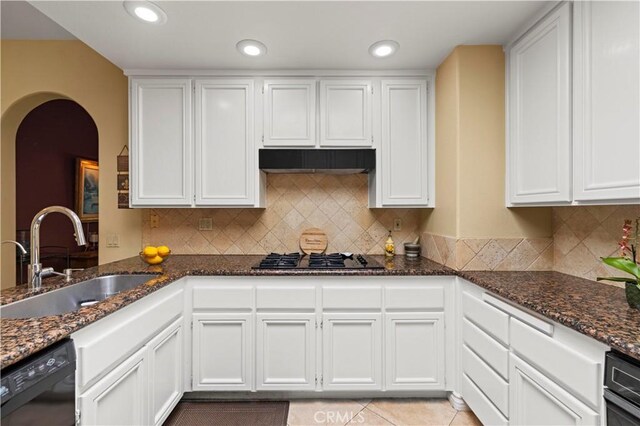 71 Via Barcaza, Coto De Caza, CA 92679 - kitchen featuring stainless steel gas stovetop, black dishwasher, arched walkways, dark stone countertops, and white cabinets