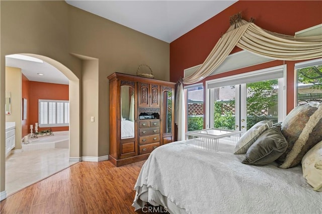71 Via Barcaza, Coto De Caza, CA 92679 - bedroom with arched walkways, a towering ceiling, and wood finished floors