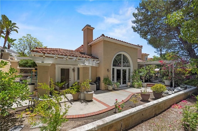 71 Via Barcaza, Coto De Caza, CA 92679 - rear view of property featuring french doors, stucco siding, a patio area, a tiled roof, and a chimney